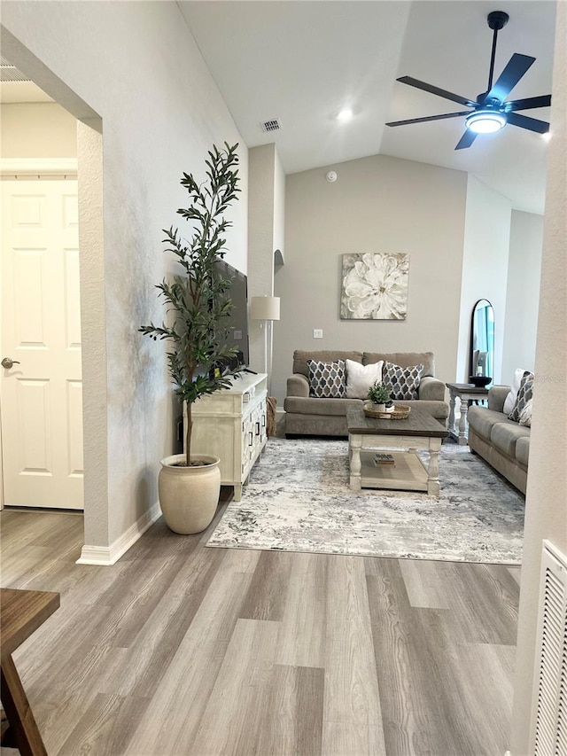 2000 Golden Beak Dr, Eagle Lake, FL 33839 - living area featuring visible vents, wood finished floors, baseboards, a ceiling fan, and vaulted ceiling