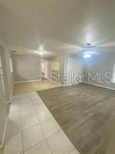 below grade area featuring tile patterned flooring and baseboards