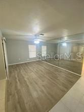 basement featuring wood finished floors and baseboards