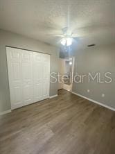 unfurnished bedroom featuring wood finished floors and baseboards