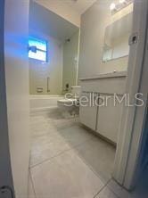bathroom featuring tile patterned flooring and a shower