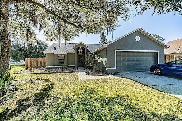 ranch-style house with driveway, fence, a front yard, stucco siding, and a garage