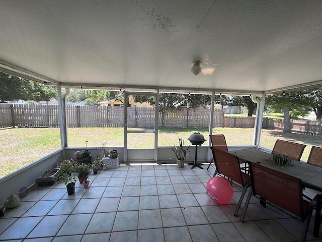sunroom / solarium with outdoor dining area and plenty of natural light
