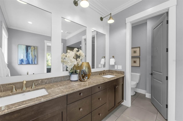 bathroom featuring toilet, tile patterned flooring, crown molding, and a sink