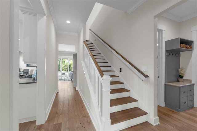 staircase with ornamental molding, recessed lighting, hardwood / wood-style floors, and baseboards
