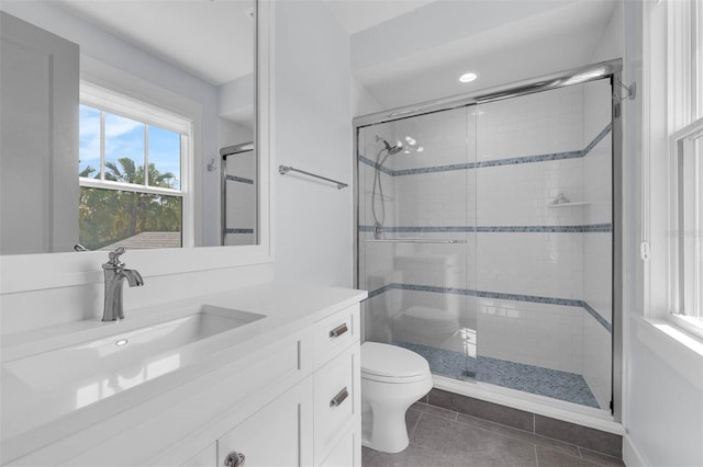 full bath with tile patterned floors, a shower stall, toilet, and vanity