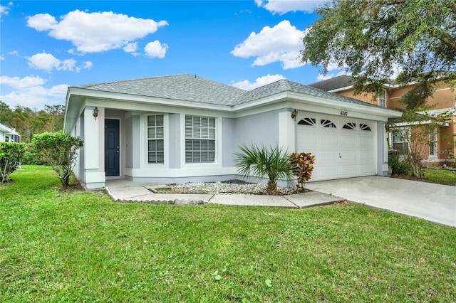 4347 Creekside Blvd, Kissimmee, FL 34746 - view of front of property featuring stucco siding, an attached garage, concrete driveway, roof with shingles, and a front lawn