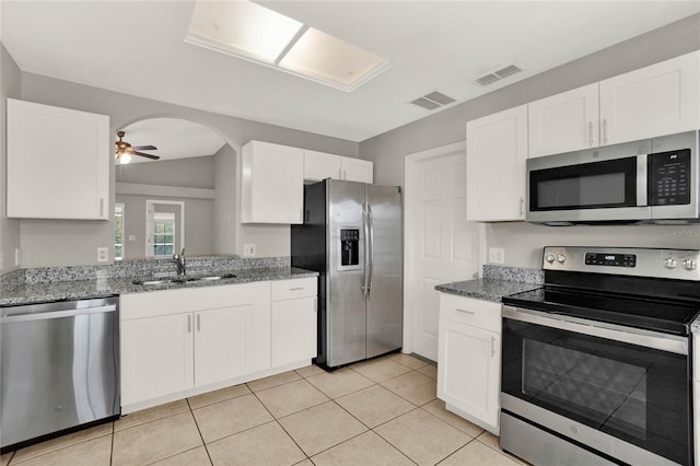 4347 Creekside Blvd, Kissimmee, FL 34746 - kitchen with stainless steel appliances, ceiling fan, white cabinets, and stone countertops