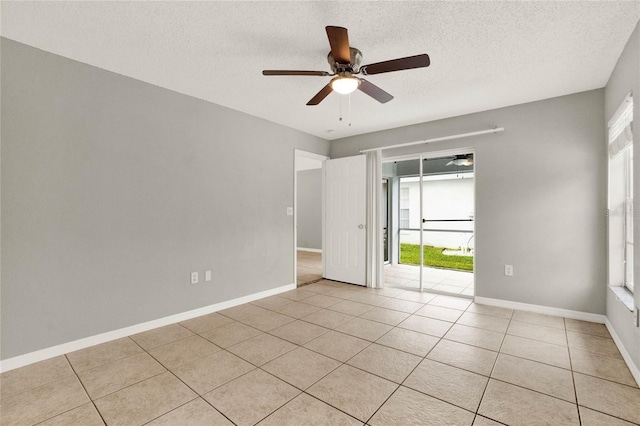 4347 Creekside Blvd, Kissimmee, FL 34746 - spare room with light tile patterned floors, a ceiling fan, a textured ceiling, and baseboards