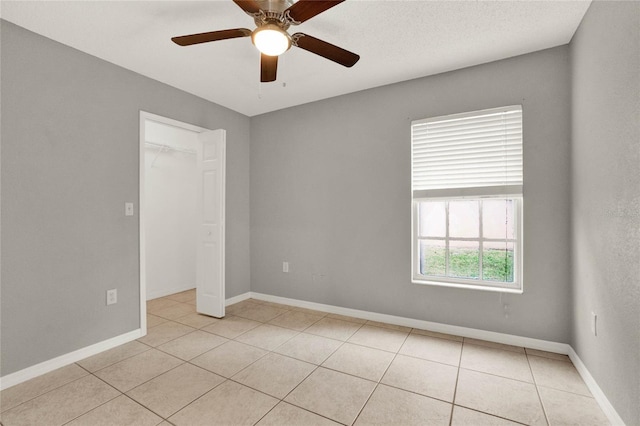 4347 Creekside Blvd, Kissimmee, FL 34746 - unfurnished room featuring light tile patterned floors, ceiling fan, and baseboards
