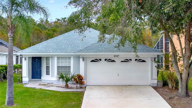 4347 Creekside Blvd, Kissimmee, FL 34746 - single story home with roof with shingles, a garage, driveway, and stucco siding