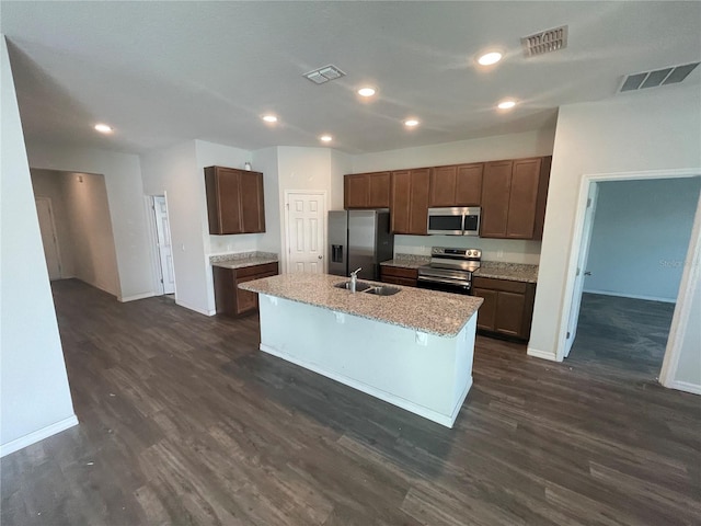 kitchen with appliances with stainless steel finishes, visible vents, baseboards, and a sink