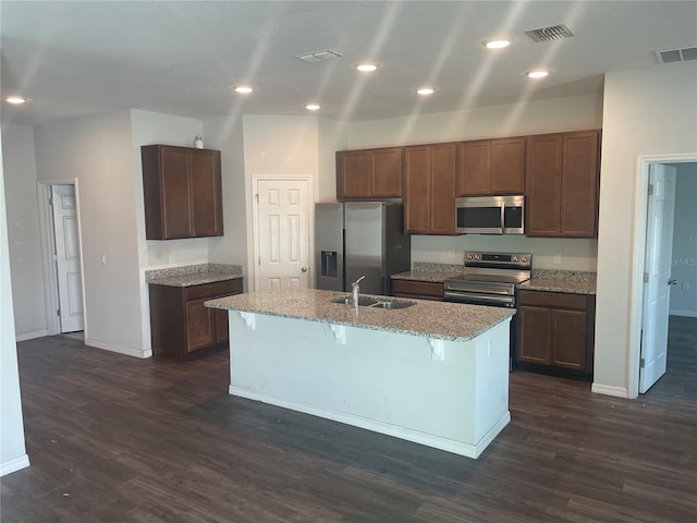 kitchen featuring baseboards, stainless steel appliances, dark wood-style flooring, and a sink