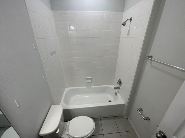 full bathroom with toilet,  shower combination, and tile patterned flooring