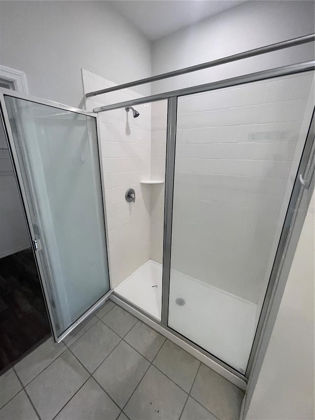full bathroom with tile patterned floors and a shower stall