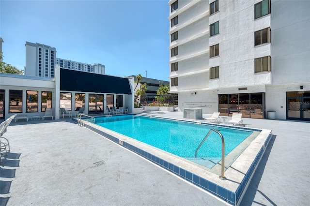 pool with central air condition unit and a patio