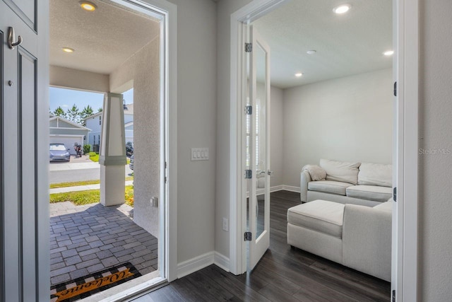 entryway featuring baseboards, recessed lighting, and dark wood-type flooring