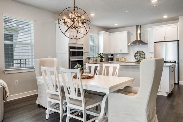 dining space with recessed lighting, baseboards, a notable chandelier, and dark wood-style floors