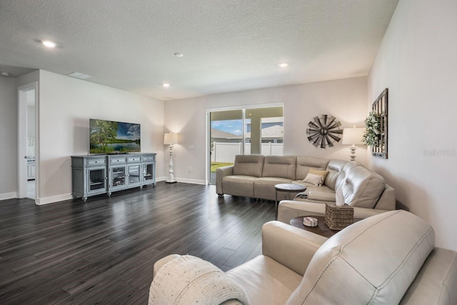 living area with a textured ceiling, baseboards, and dark wood-style floors