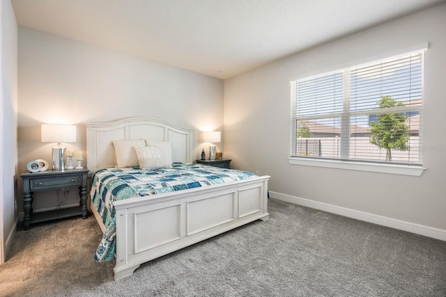 bedroom with baseboards and light colored carpet