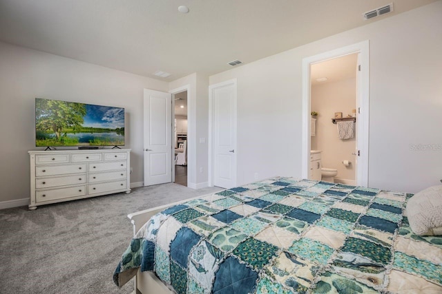 carpeted bedroom with connected bathroom, baseboards, and visible vents