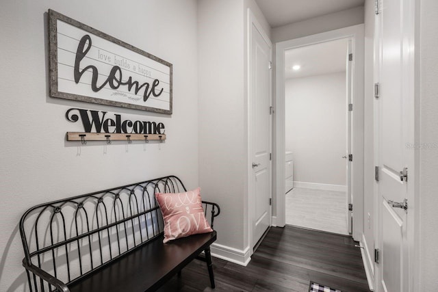 hall with baseboards and dark wood-style floors