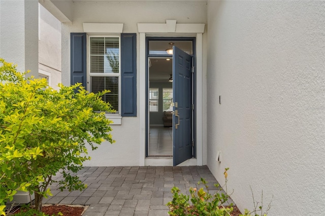 entrance to property featuring stucco siding