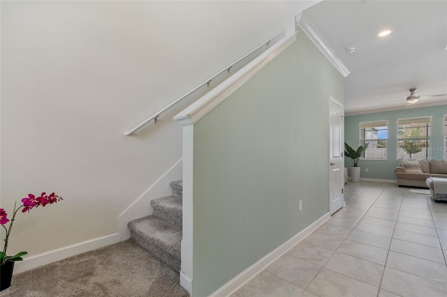 stairs with ornamental molding, tile patterned flooring, ceiling fan, and baseboards