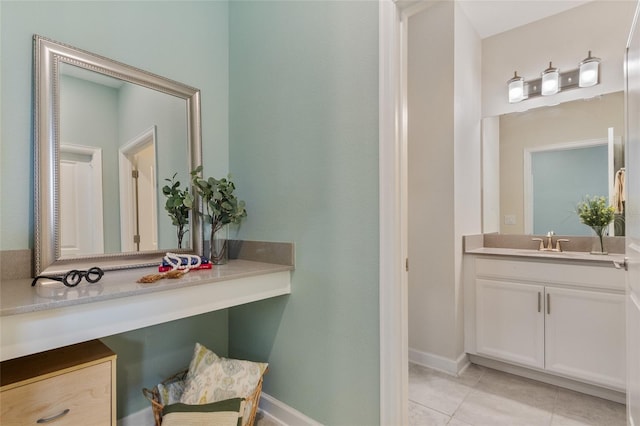 bathroom featuring tile patterned flooring, vanity, and baseboards