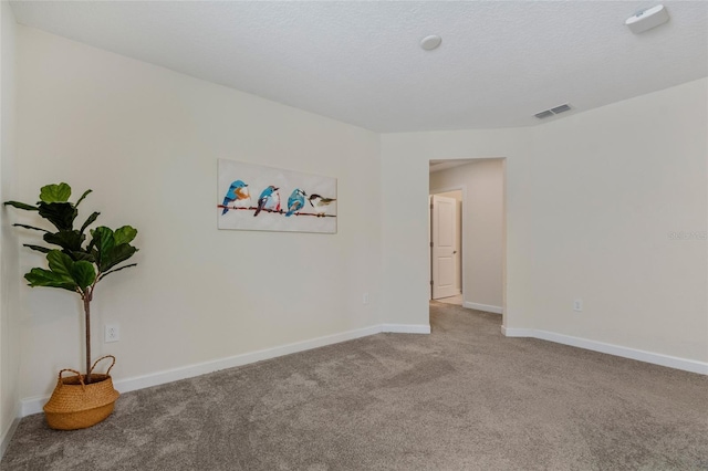 unfurnished room with visible vents, carpet floors, and baseboards