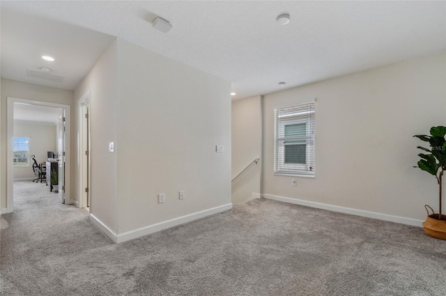 unfurnished room featuring baseboards, a wealth of natural light, and carpet flooring