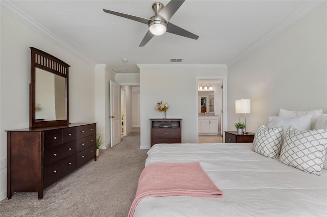 bedroom featuring light colored carpet, visible vents, ensuite bathroom, ornamental molding, and a ceiling fan