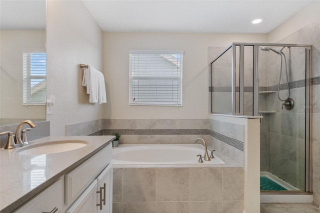 full bath with a stall shower, a bath, and vanity
