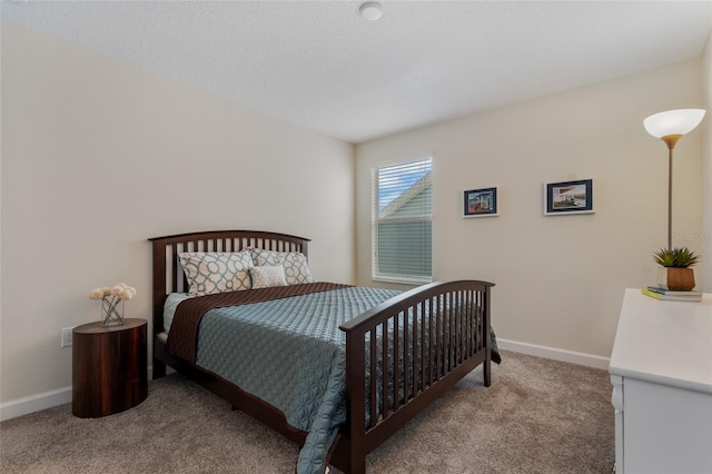 carpeted bedroom featuring baseboards