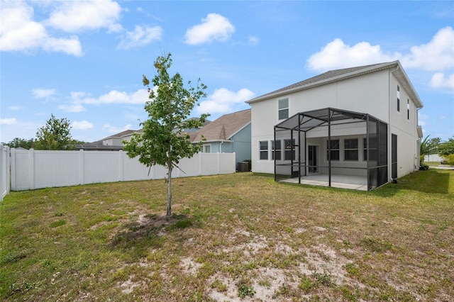 back of house with a lawn, a patio area, stucco siding, and a fenced backyard