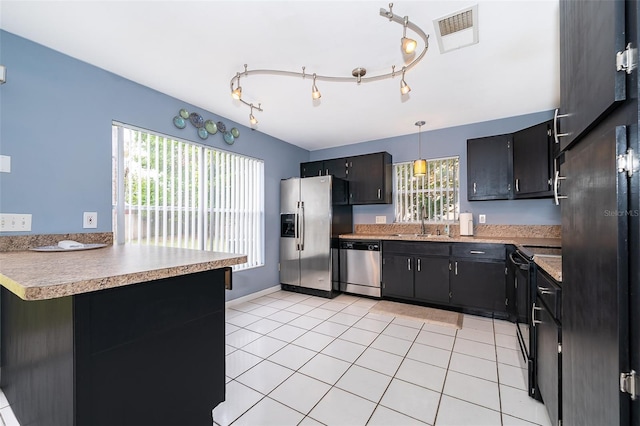 kitchen with visible vents, stainless steel appliances, light tile patterned floors, and plenty of natural light