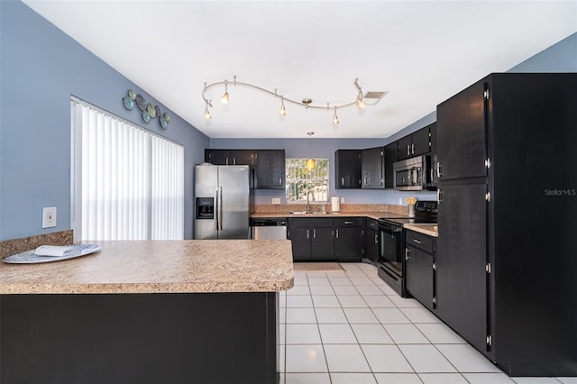 kitchen with a sink, light tile patterned flooring, black appliances, a peninsula, and light countertops