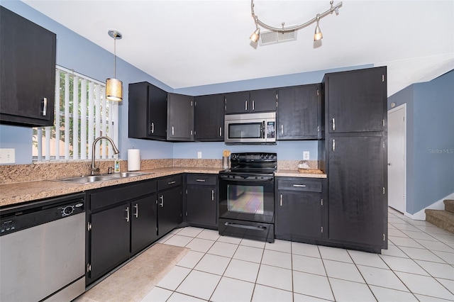 kitchen with a sink, stainless steel appliances, light tile patterned floors, visible vents, and light countertops