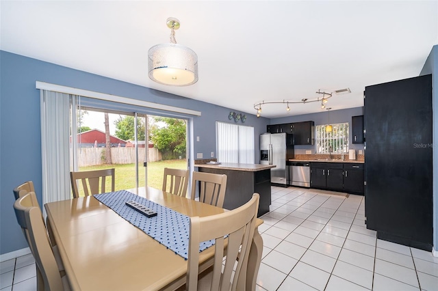 dining area with light tile patterned flooring and visible vents