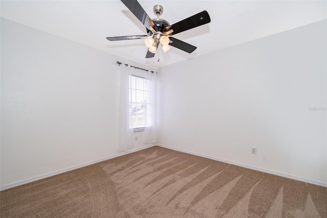 carpeted empty room with baseboards and ceiling fan