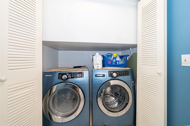laundry room featuring separate washer and dryer and laundry area