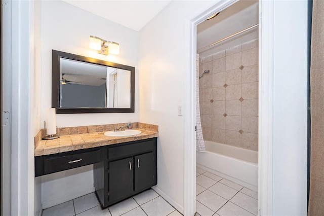 full bath featuring vanity, a ceiling fan, shower / bathtub combination with curtain, and tile patterned floors