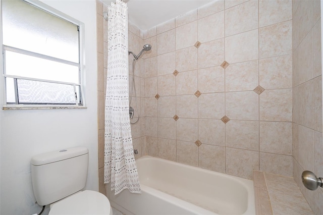 bathroom with shower / tub combo and toilet