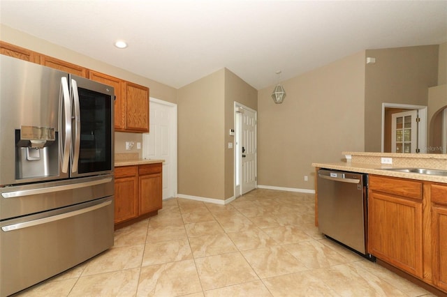 212 Regency St, Davenport, FL 33896 - kitchen featuring light countertops, stainless steel appliances, brown cabinets, and baseboards