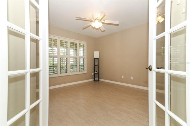 212 Regency St, Davenport, FL 33896 - spare room with baseboards, a ceiling fan, french doors, and light wood finished floors