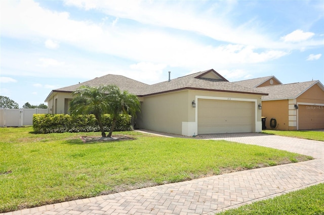 212 Regency St, Davenport, FL 33896 - single story home featuring a front lawn, fence, decorative driveway, stucco siding, and an attached garage