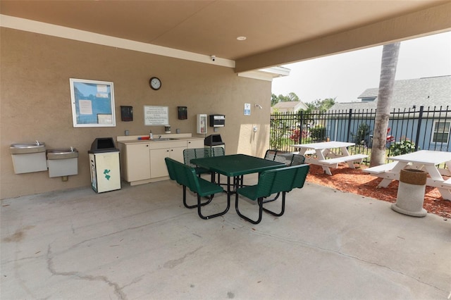 212 Regency St, Davenport, FL 33896 - view of patio / terrace featuring fence, a sink, outdoor dining area, and an outdoor kitchen