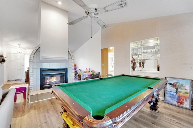 516 Fort Smith Blvd, Deltona, FL 32738 - recreation room with wood finished floors, ceiling fan, billiards table, a tile fireplace, and vaulted ceiling