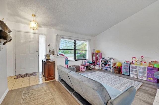 516 Fort Smith Blvd, Deltona, FL 32738 - living area featuring a textured ceiling, wood finished floors, and lofted ceiling