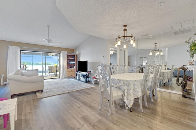 516 Fort Smith Blvd, Deltona, FL 32738 - dining area with a textured ceiling, light wood-type flooring, a chandelier, lofted ceiling, and a ceiling fan